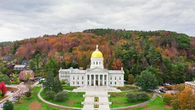 Aerial establishing shot of Vermont State House, in Montpelier, VT with slow camera approach towards the iconic golden dome. The capitol is the seat of the Vermont General Assembly.
