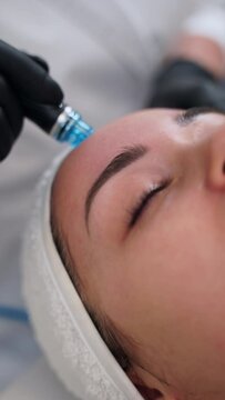 Skincare specialist performs hydrafacial treatment on client. Hydro dermabrasion technique cleanses, exfoliates, extracts, hydrates skin. Beauty spa offers anti-aging facial rejuvenation services.
