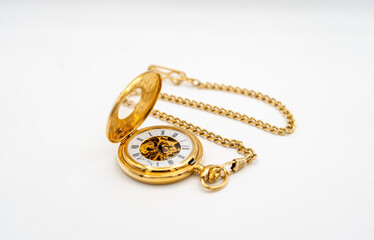 Gold pocket watch on white background