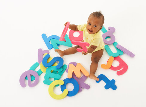 Baby Surrounded by Letters