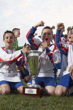 Soccer Team With Gold Medals and Trophy