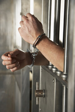 Man Handcuffed to Cell Door