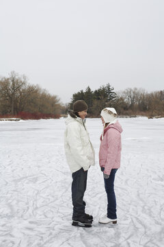 Couple Looking at Each Other on Ice Rink