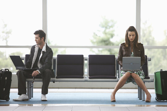 Man and Woman in Airport Waiting Area