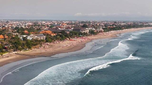 Aerial 4K footage of Seminyak beach coastline. The famous and luxury Kuta beach resort in southern Bali, Indonesia. Sunny drone video