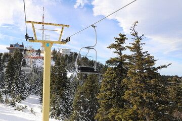 Ski Lift snowy mountain winter forest with chair lift At The Ski Resort in winter. Snowy weather...