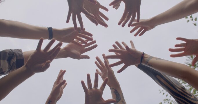 strong sense of teamwork, camaraderie, shared commitment to success. People lifestyle Team members come together by holding hands working closely together to achieve common goal. 