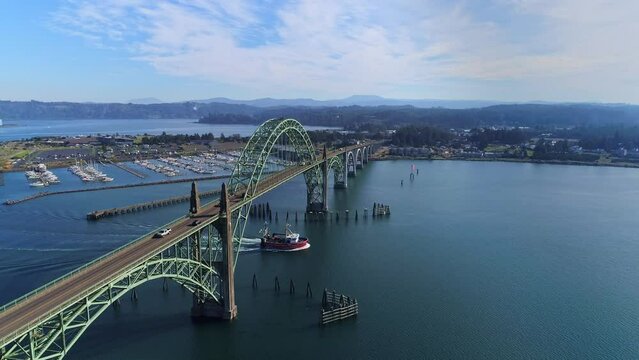 Fishing-vessel-departs-Yaquina-Bay-travels-under-Bay-Bridge-Newport-Oregon