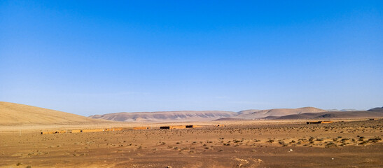 Fototapeta na wymiar Beautiful natural view of moroccan desert landscape on sunny day with beautiful blue sky. Moroccan southern regions hills.