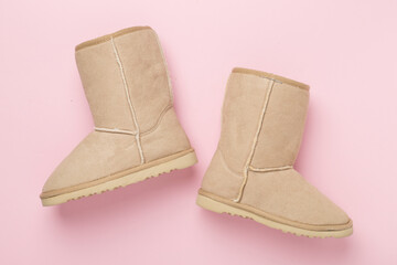 Beautiful woman ugg boots on color background,top view