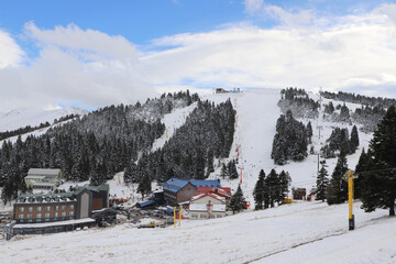 Ski lifts in winter. Ski lifts, snowy mountain and forest at the Ski Center in winter. Ski...