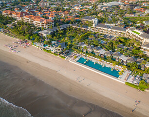 Aerial view of Seminyak beach coastline. The famous and luxury Kuta beach resort in southern Bali,...