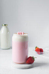 Pink latte with cream in a can shaped glass, strawberry raspberry latte in a glass shaped like a can, Aesthetic cafe pink latte in a can glass