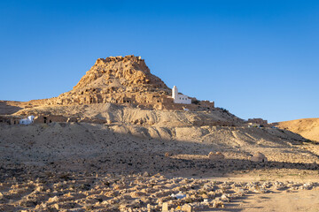 Small mosque on a hill above a cemetery near Tataouine.