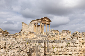 The Capitol Temple at the Roman ruins of Dougga, Tunisia. - obrazy, fototapety, plakaty