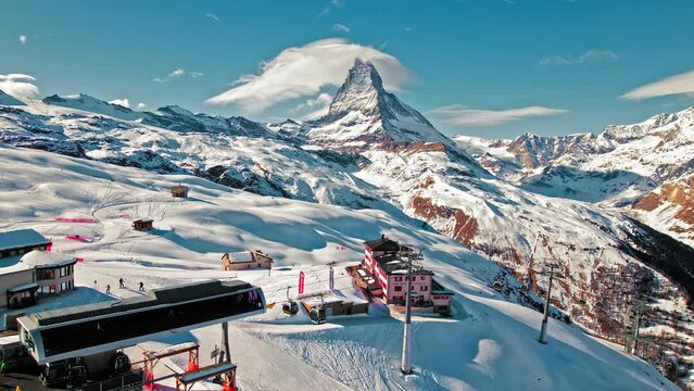 Aerial view of a ski resort with cable car in Zermatt Riffelberg mountain station. Tourists enjoying vacation at the Matterhorn Swiss mountain in the Alps in Europe at the Riffelhaus 4-star hotel.