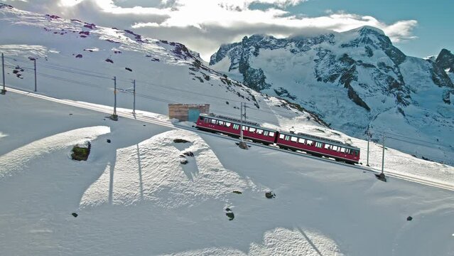 Aerial view of Swiss electrified cog railway train ride to the Gornergrat in Zermatt. View from above of the train with tourists in the Alps in Europe, Switzerland.