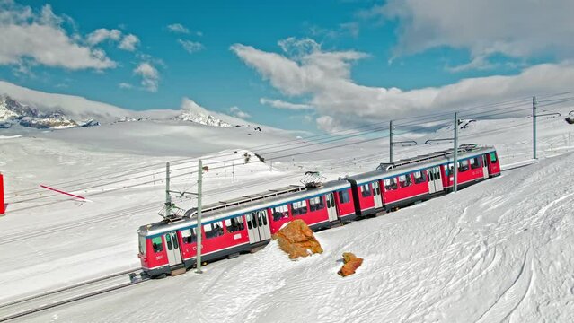 Aerial view of Swiss electrified cog railway train ride to the Gornergrat in Zermatt. View from above of the train with tourists in the Alps in Europe, Switzerland.