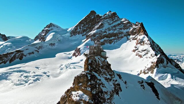 Scenic view from above of Mountaintop Sphinx observatory at Jungfrau station. Aerial view of the highest accessible railway in Europe, Swiss Alps in Switzerland.
