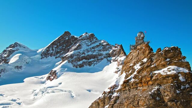 Scenic view from above of Mountaintop Sphinx observatory at Jungfrau station. Aerial view of the highest accessible railway in Europe, Swiss Alps in Switzerland.