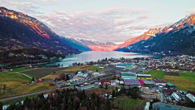 Aerial view of Interlaken Resort Town in Switzerland and turquoise Lake Brienz. Panoramic sunset landscape of the residential Swiss houses by Alps Mountains in Europe