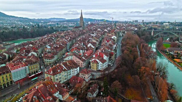 Aerial view of Aare River and Berner M&uuml;nster Cathedral in Old Town of Bern, Switzerland. Panoramic view of red rooftop houses of medieval townscape, Gothic architecture in Europe.
