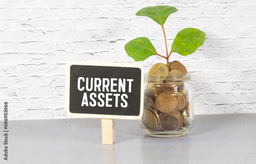 Poster current assets text on clipboard with keyboard on wooden background