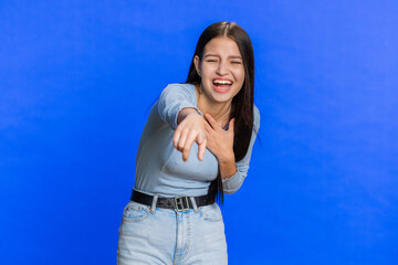 Amused lovely woman pointing finger to camera, laughing out loud, taunting making fun of ridiculous...