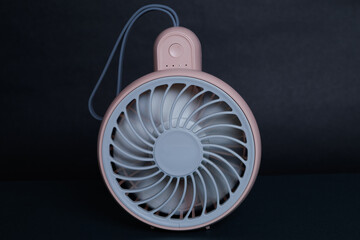 Mini electric pink Fan on Dark Background