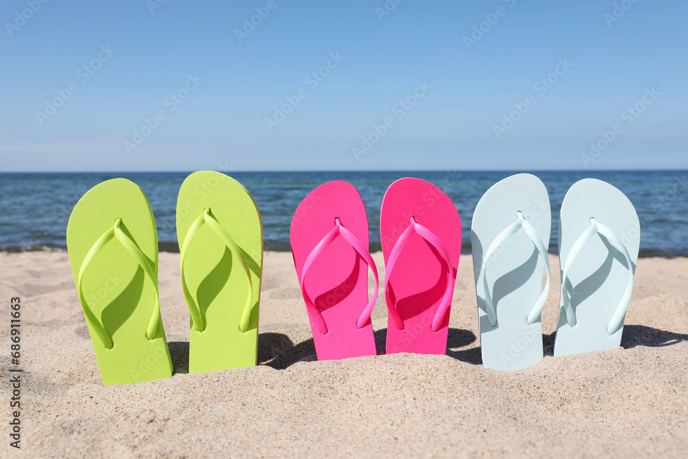 Canvas Prints Stylish colorful flip flops on beach sand