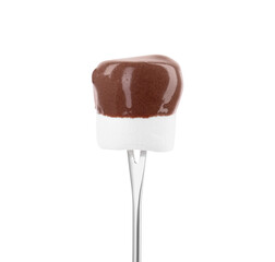 Marshmallow with melted chocolate on fondue fork against white background