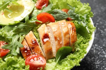 Delicious salad with chicken, cherry tomato and avocado on table, closeup