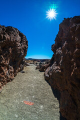 Rocks of Las Canadas caldera of Teide volcano. Mirador (viewpoint) Minas de San Jose Sur. Tenerife. Canary Islands. Spain. Lens flare.