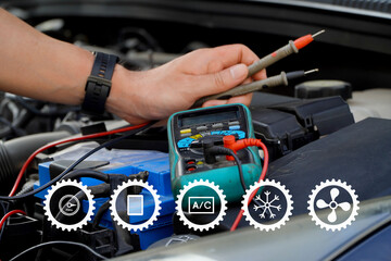 Car care maintenance and servicing.technician checks the battery using a voltmeter capacity tester,