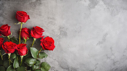 red roses on grey concrete surface background with copy space for decorative design element - obrazy, fototapety, plakaty