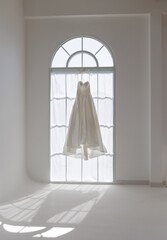 Ethereal Wedding Dress Floating in Sun Drenched Ceremony Room