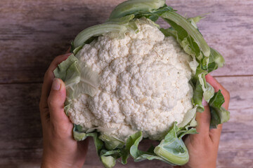 hand holding cauliflower