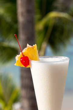 Cocktail on the beach in Tahiti over the ocean with pineapples and cherry and a pina collada 