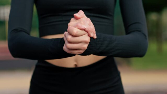 Close-up of a woman's hand scratching a fresh large mosquito bite on her stomach in summer park