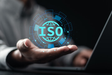 ISO quality control assurance standards business concept. Businessman use laptop and show ISO and globe icons on virtual screen. business standard auditing quality control certification.