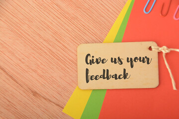 Wooden hang tags written with GIVE US YOUR FEEDBACK.