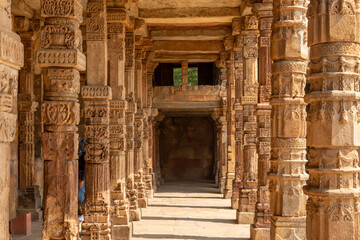 Carving Sandstone Columns in the courtyard of Quwwat-Ul-Islam mosque inside Qutub Minar complex Delhi India