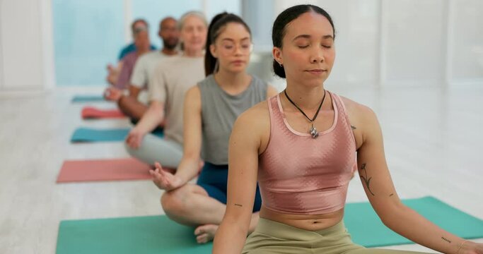 Calm woman, coach and meditation in yoga class for spiritual wellness, awareness or stress relief. Female person or yogi with group in mediating or zen for healthy mind, body and health in fitness