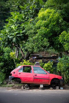 An old fashioned car in Tahiti on a tropical island 