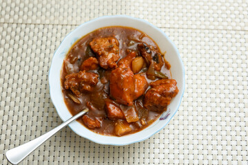 Chilly chicken with Kerala parathas porotta roti parotta barotta naan layered flatbread made from maida whole wheat flour. Eat with spicy Asian chicken beef egg curry gravy. Indian food.