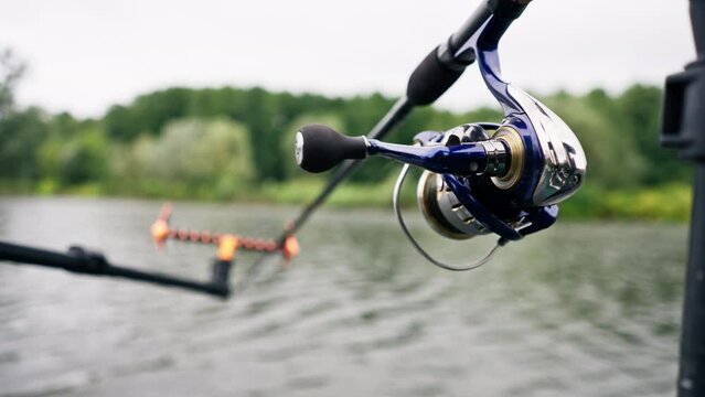 close-up spinning on the background of dark river water sports fishing hobby active recreation professional equipment