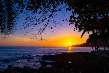 Beautiful colorful sunset or sunrise sky over sea with dramatic clouds nature environment background