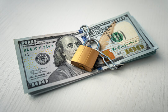 money dollars in a chain with lock on the background of white. The concept of banning dollars. the concept of keeping or banning cash dollars. money is banned.