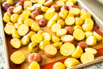 Roasting Halved Mixed Marble Potatoes in Modern Kitchen