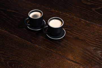 2 cups of coffee on wooden table